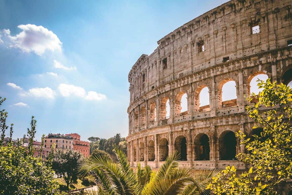 The Colosseum bathed in golden sunlight, representing the rich history and ancient architecture of Rome, Italy.