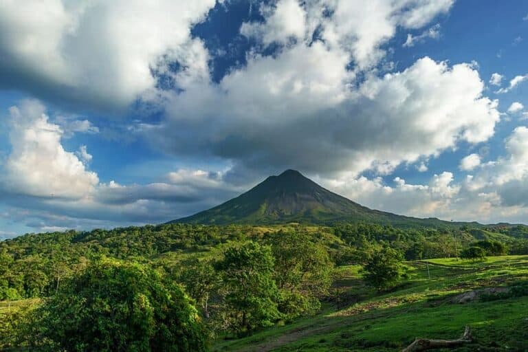 Panoramic view of Arenal Volcano towering over Costa Rica's lush forest.