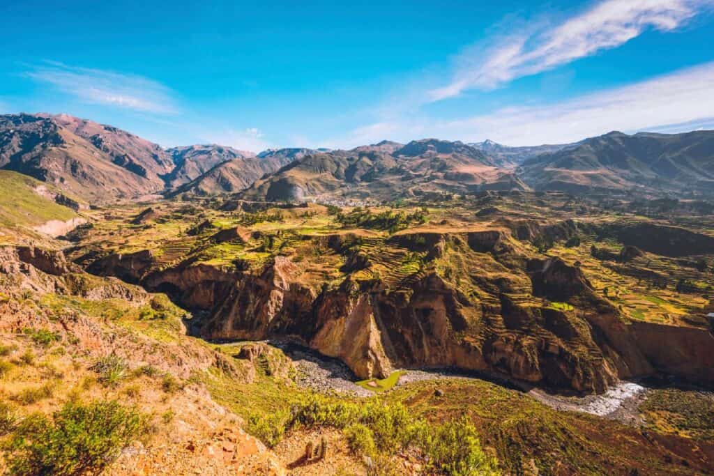 At Colca Canyon in Peru, South America, near the city of Arequipa, a river runs through a terraced field landscape.