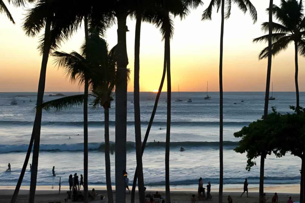Waves breaking on Tamarindo beach scene in silhouette at sunset, Guanacaste, Costa Rica.Costa Rica is the central American country north of Panama that is renowned for its tropical birdlife, exotic wildlife and adventure pursuits such as whitewater rafting, parasailing and ziplining