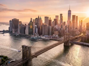 Aerial view of Manhattan skyline at golden hour from Brooklyn Bridge, New York City travel guide 2026
